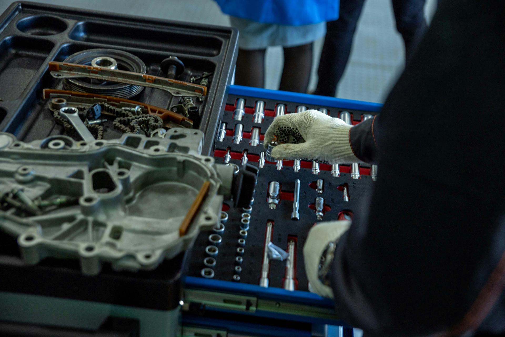 Technician at Shurlock Row garage repairs gear functionality as part of a transmission service.
